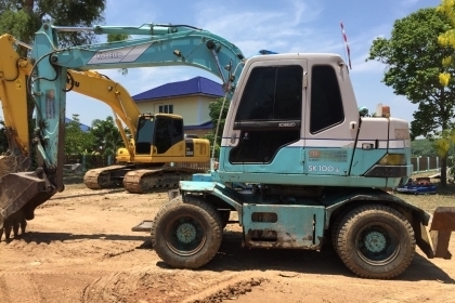 แบคโฮล้อยาง KOBELCO SK100W พร้อมหัวเจาะ +ปุ้งกี๋เอกสารเล่มทะเบียน