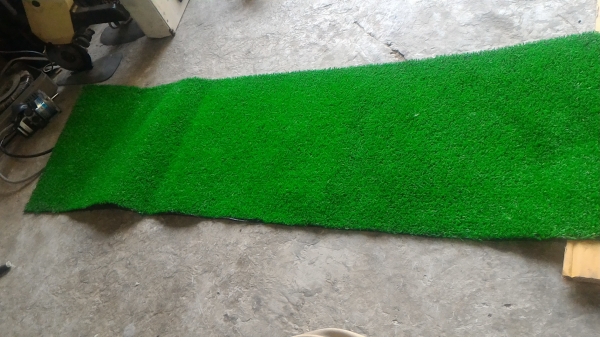 พรมพัตต์กอล์ฟยาวประมาณ 2 เมตร มีรางส่งลูกคืน พืนหนาเหมือนหญ้าจริง